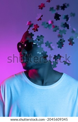 Collage of young african man in sunglasses looking away isolated over gradient purple background. Male head consist of puzzle pieces. Concept of diversity, psychology. Youth culture. Copy space for ad