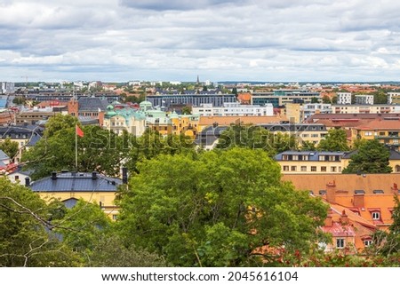 Beautiful panoramic view over city landscape under blue sky with puffy white clouds. Europe. Sweden. Uppsala.