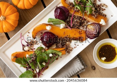 Roasted pumpkin with cheese and quinoa, healthy pumpkin dish. Top view.