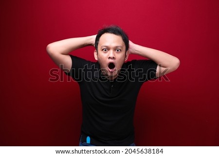 Wow and shocked face of Young Asian man with open hand gesture. Advertising model concept.