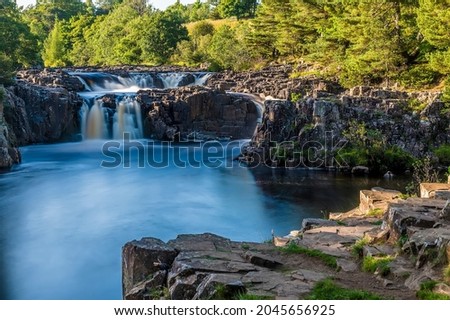 A long exposure view across the Lower Force waterfall on the River Tees in summertime Royalty-Free Stock Photo #2045656925