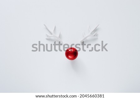 Creative beautiful Christmas greeting card with funny reindeer face.  Royalty-Free Stock Photo #2045660381