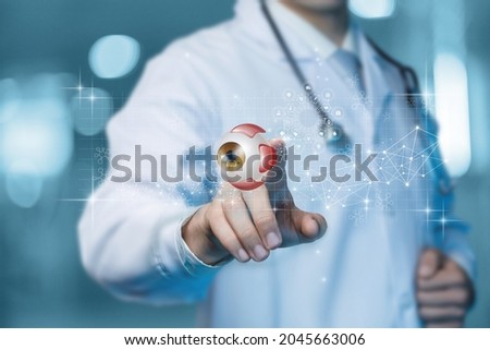 Doctor ophthalmologist clicks on a virtual computer screen on a model eye. Royalty-Free Stock Photo #2045663006