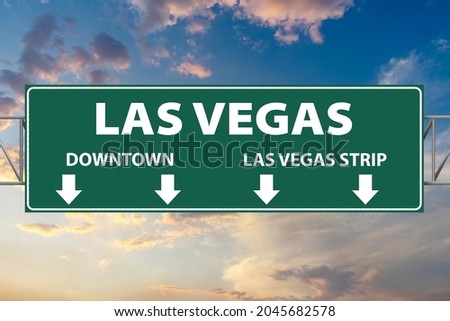 Las Vegas illustration freeway green sign with arrows for Downtown and Las Vegas Strip  Royalty-Free Stock Photo #2045682578