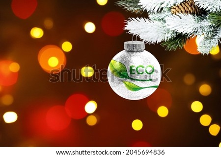 Colorful blurred background and applied the flag of Ecology logo on the New Year's toy. New Year 2022 Celebration