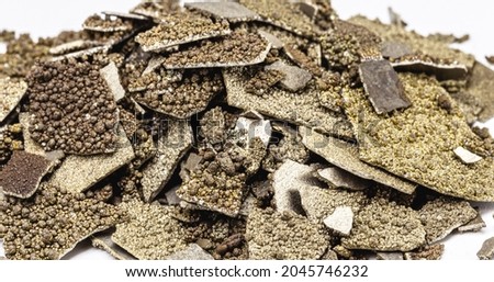 Manganese samples, flaked pure manganese metal used in industry, isolated white background. Royalty-Free Stock Photo #2045746232