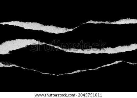 Paper tear, ripped paper edge, torn edge, isolated paper tear white on black, paper corner with space for copy Royalty-Free Stock Photo #2045751011