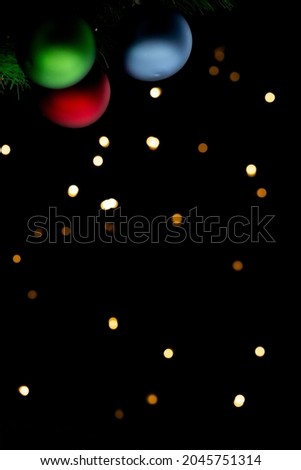 christmas baubles on a garland of lights background
