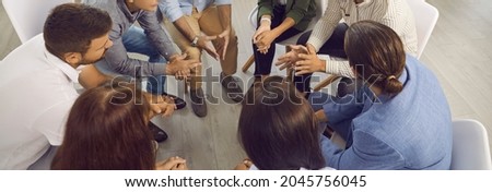 Banner background with business team having discussion in work meeting. Group of people sitting in circle and having conversation with experienced business trainer who's sharing advice and expertise