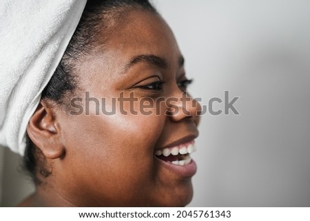 Black girl having fun while wearing body towel - Main focus on left eye