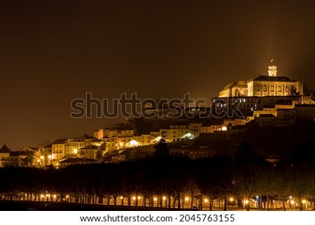 urban photography of the city of Coimbra (Portugal) illuminated at night. View on the university located on the top of a hill of the city and overhanging the Mondego river 
 Royalty-Free Stock Photo #2045763155