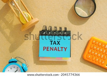 Notes with the words Tax Penalty. Underpayment of estimated tax by person, financial institution or business. Taxation. Finance concept. Fine Royalty-Free Stock Photo #2045774366