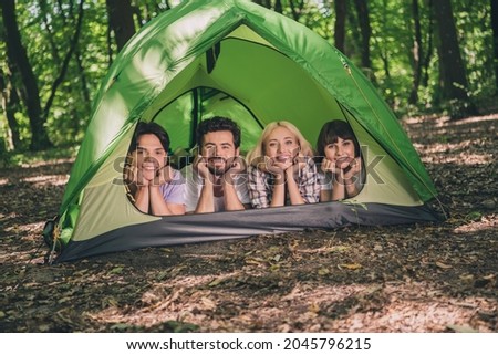 Photo of best friends happy positive smile lying camp hands touch cheeks expedition extreme nature forest trip outdoors