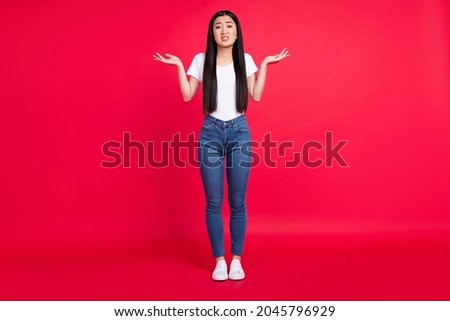 Full body photo of young attractive asian girl unhappy negative shrug shoulders clueless confused isolated over red color background Royalty-Free Stock Photo #2045796929