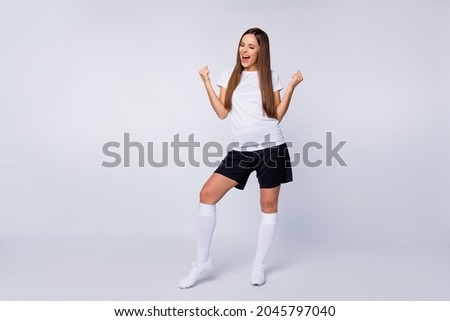 Goal Full length photo of cheerful sports fan lady raise fists supporting players wear favorite football team uniform t-shirt shorts long socks cleats isolated white color background