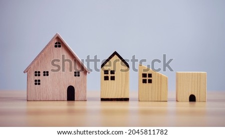 Difference house wood model on table background, Planning to buy property.