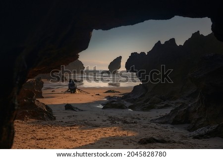 Buelna beach, llanes, asturias. Photographer taking pictures at dawn.