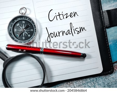 Business concept.Text Citizen Journalism writing on notebook with pen,compass and magnifying glass wooden background