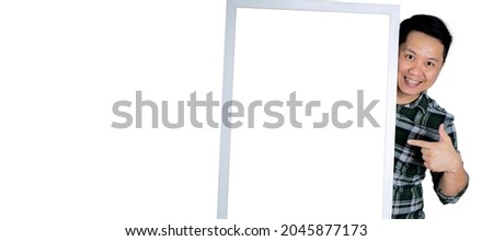 Happy young man in his 40s holding a gray frame. put your finger on the frame white isolated background