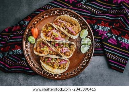 mexican tacos flat lay composition with pork carnitas, cochinita pibil, onion and habanero chili traditional food in Mexico