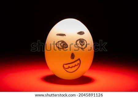 smiling egg face highlighted in dark