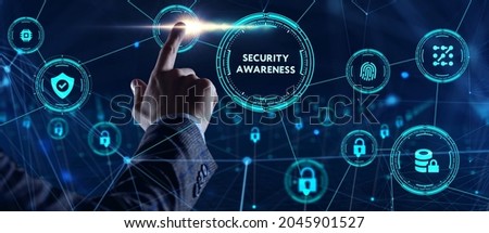 Cyber security data protection business technology privacy concept. Young businessman  select the icon Security Awareness on the virtual display.