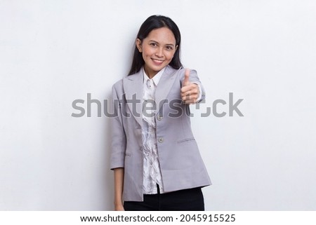 young asian beautiful business woman with ok sign gesture tumb up isolated on white background
