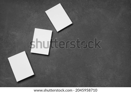 Blank sheets of paper on dark background