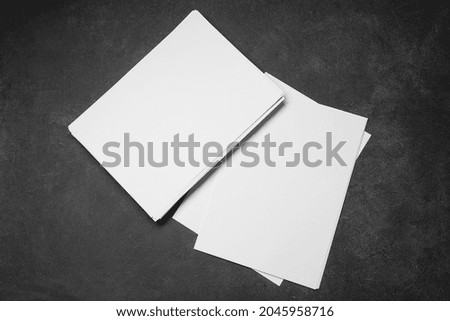 Blank sheets of paper on dark background