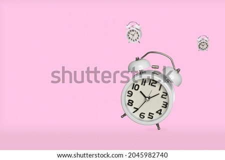 Alarm clocks isolated on pink background with copy space. 