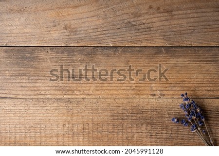 Bunch of dried lavender flowers on the rustic wooden background. Shot from above.
