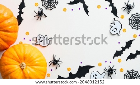 Happy Halloween frame made of pumpkins, ghosts, bats, spiders, web on white background. Flat lay, top view, copy space. Halloween banner mockup.