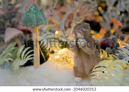 puppet squirrel sit in a fairy snowy forest. Christmas installation.