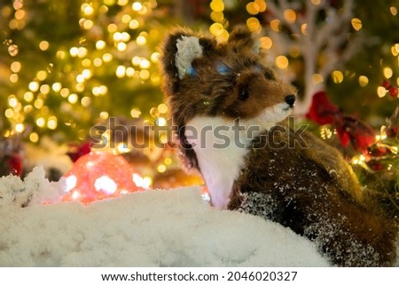 puppet fox sit in a fairy snowy forest. Christmas installation.