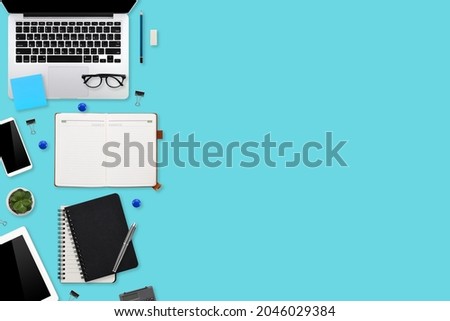 flat lay workspace table desk with laptop computer, office supplies, coffee cup, tablet and mobile smartphone on color background