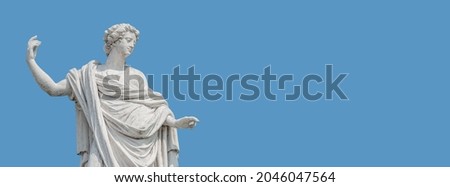Old roof statue of a beautiful Renaissance Era woman philosopher and poet with her hand up as she declares something in Potsdam at white blue sky background and copy space, Germany Royalty-Free Stock Photo #2046047564