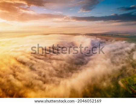 Picturesque scene of plain in the fog from a bird's eye view. Location place Dniester canyon, Ukraine, Europe. Aerial photography, drone shot. Perfect natural wallpaper. Discover the beauty of earth.