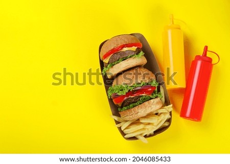 Concept of fast food on yellow background