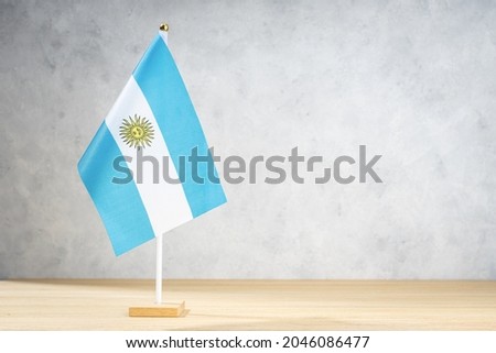Argentina table flag on white textured wall. Copy space for text, designs or drawings