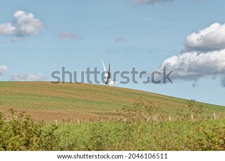 Landscape view of a wind turbine on a sunny day