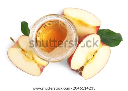 Delicious cider in glass near pieces of ripe apple on white background, top view Royalty-Free Stock Photo #2046114233