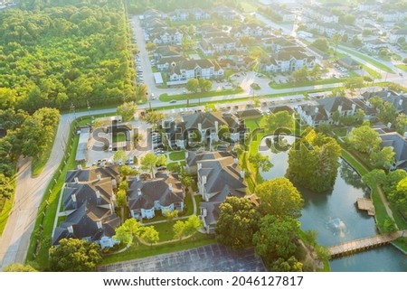 Above Houston , Texas suburb area west of downtown with morning golden hour sunlight aerial view