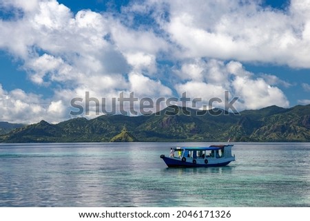
the beauty of the landscape of the messah island in the morning, a ship carrying passengers from the surrounding island, NTT-Indonesia. March 29 2019 Royalty-Free Stock Photo #2046171326