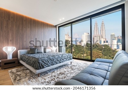 Modern and contemporary bedroom with white ceiling and wood accents with views of Kuala Lumpur skyline. Condo or Hotel accommodation. Royalty-Free Stock Photo #2046171356