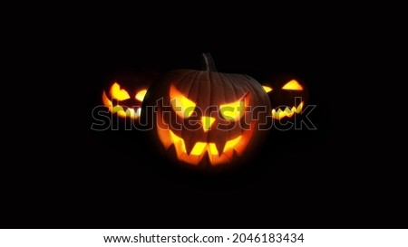 Scary Pumpkins glow at night. Halloween picture on a black background. Fear and the holidays concept 