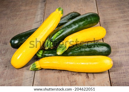 Zucchini and yellow squash on a wooden table Royalty-Free Stock Photo #204622051