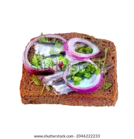 Black bread sandwich with black sea sprat carcasses with large onion rings isolated on white background.