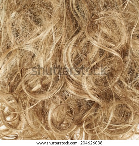 Curly hair fragment as a texture background composition
