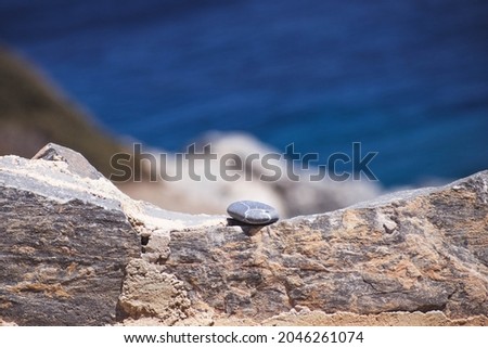 Beautiful stacked rocks next to the greek beach