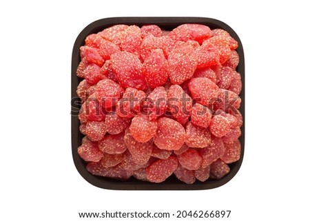candied fruit, dried strawberry with sugar in wooden bowl closeup. vegetarian food isolated on white.